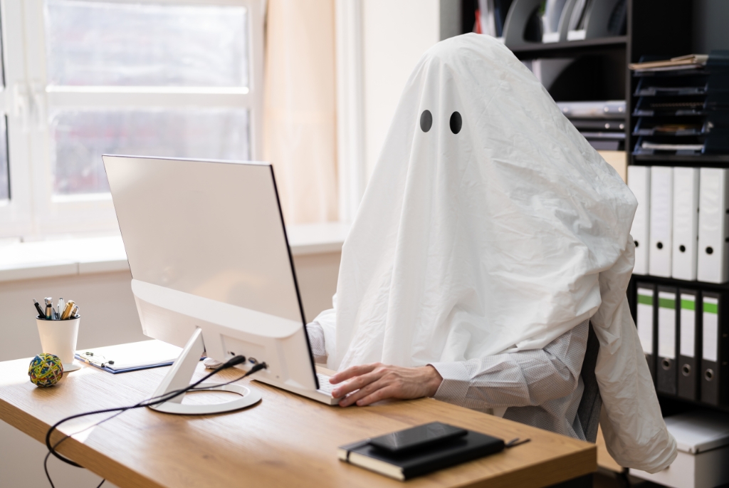 Banking recruiter in ghost suit at computer while being ghosted after a job offer
