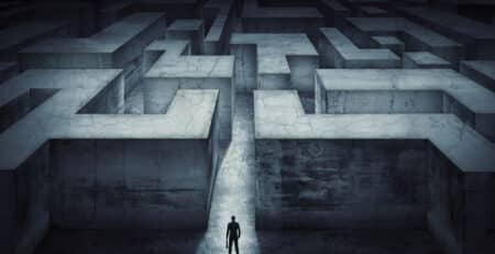 COO Executive Recruitment standing in front of a dark shadowy maze