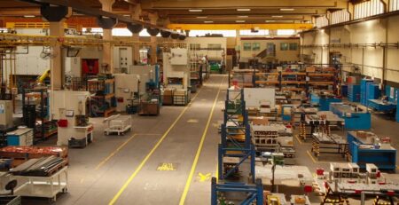 Factory floor with various tables and racks being prepared for Manufacturing M&A activity