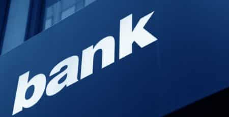 "Bank" in white letters across blue building facade
