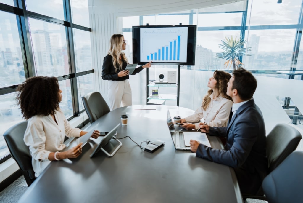 Executive in the pharma industry giving presentation to group of employees in a conference room